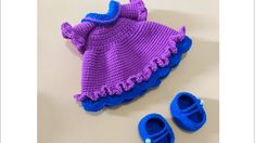 a knitted purple and blue outfit with matching slippers is shown next to a pair of baby shoes