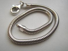 Here is a beautiful real 925 Sterling Silver 5mm Snake chain necklace with a lobster clasp. This necklace can be used as is or with any type of charm or pendant. Heavy Duty! Length:22 inch Thickness: 5mm Other lengths are also available. Can be oxidized. Please contact for details. Silver Snake Bracelet, Gold Snake Chain, 20 Inch Necklace, Red String Bracelet, Snake Chain Necklace, Toggle Necklace, Snake Chain Bracelets, Snake Bracelet, Snake Necklace