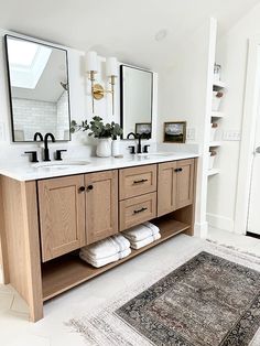 a bathroom with two sinks, mirrors and rug in front of the sink countertop