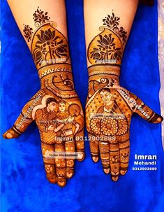 two hands painted with henna designs on them