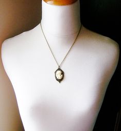 Beautiful cream cameo with a black background set in antique brass paired with antique brass chain. Cameo features a detailed woman with roses and curls in her hair. Details: Pendant measures approx 1.5 inches in length Necklace measures 18 inches Setting and chain are plated brass Cameo is hard, matte resin Thank you for shopping Delicate Industry :) Grecian Women, Black Cameo, Cameo Pendant Necklace, Gift Ideas For Mom, Jewelry Classic, Jewelry Holiday, Cameo Jewelry, Holiday Gift Ideas, Cameo Necklace