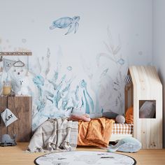 a child's room decorated in blue and white with sea animals on the wall