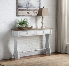 a white table with two drawers and a lamp