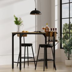 a table with two stools next to it in front of a window