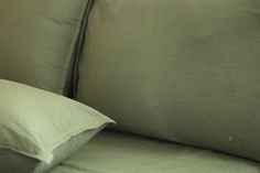 a close up view of two pillows on a couch with the covers pulled back and turned down