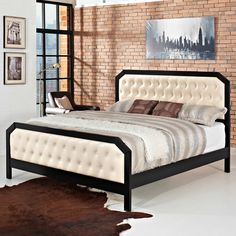 a bedroom with a brick wall and white bed in the center, along with a cow hide rug on the floor