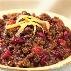 a bowl filled with chili and cheese on top of a table