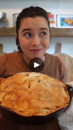 a woman sitting at a table with a pie in front of her and the caption that reads, what is it?