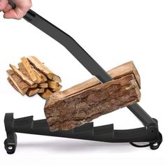 a person is holding a knife over a log on a stand with firewood in it