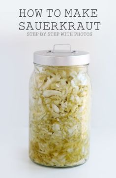 a jar filled with sauerkraut sitting on top of a white countertop