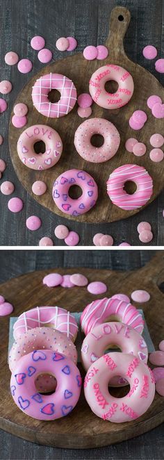 pink donuts with sprinkles are arranged on a wooden platter and placed on a table