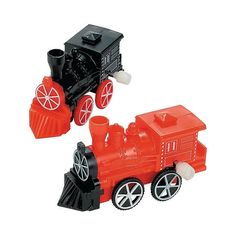 two toy trains sitting next to each other on a white surface and one is red