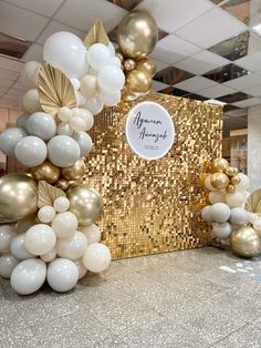 balloons and confetti are arranged on the floor in front of a gold sequin backdrop