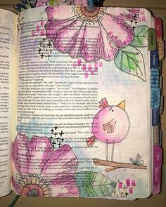 an open book with flowers and birds on it