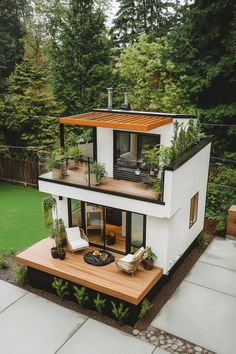 a white house sitting on top of a lush green hillside covered in trees and plants