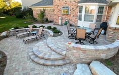 an outdoor patio with stone steps and seating