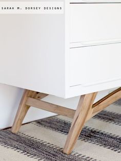 a white dresser sitting on top of a rug