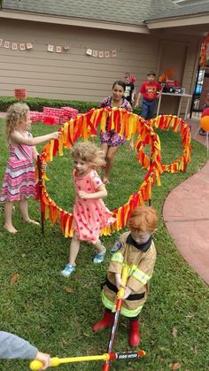 children playing with fireman's gear in the yard