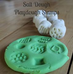 a playdough stamp is sitting on a wooden table