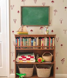 there is a book shelf with books on it and a chalkboard in the corner