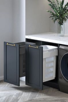 a washer and dryer sitting in front of a counter with a vase on it