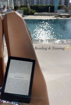 a person sitting next to a swimming pool with a book in their lap and the words reading & tuning on it