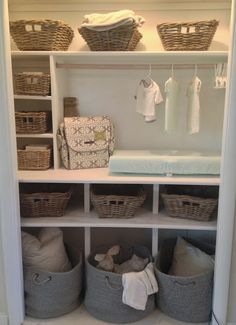 an organized closet with baskets and clothes