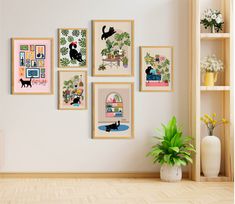 there are many pictures on the wall with plants in them and a potted plant next to it