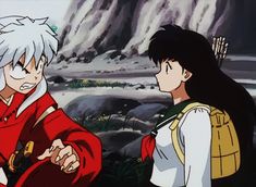 two anime characters standing next to each other in front of a rocky area with trees