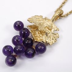 "This Amethyst Grape Necklace and Dangle Earring set is a larger size version of the other ones I have listed here. They have a natural looking grape cluster with two overlapping 14kt yellow gold vermeil grape leaves with a lot of fine detail . The necklace design contains nine 3mm. Dark Purple Amethyst gemstones and the Earrings contain eighteen gemstones. The Amethyst gemstones are clustered in a natural looking way like an actual cluster of grapes. The pendant comes with a 14kt. Gold Vermeil Amethyst Fine Jewelry For Evening, Purple Amethyst Jewelry For Evening, Formal Amethyst Briolette Jewelry, Purple 14k Gold Dangle Jewelry, Elegant Grape Colored Jewelry For Gift, Grape Necklace, Cluster Jewelry, Chunky Jewelry, Necklace Design