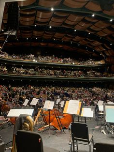 an auditorium full of people with musical instruments