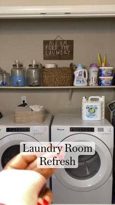 the laundry room is clean and ready to be used by someone with dryer in hand