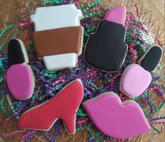 some decorated cookies on a table with confetti