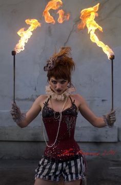 a woman with fire sticks in her hands