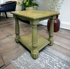 a green table sitting on top of a wooden floor