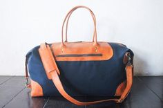 "Weekend bag perfect for overnight travel or extended weekends. Handmade in waxed canvas and leather. Perfect for anniversary gift for men and women. In Navy Blue colour canvas and tanned leather but available in many other colours, please check rest of my store for more colours. DIMENSIONS: w 20\" x H 10\" x D 10\" inches - w 51 cm x 25.5 cm x D 25.5 cm Our most popular duffle in vegetable tanned leather and canvas - perfect as a gift or treat for your self. Our goal is to make high quality bag Navy Duffle Bag With Luggage Sleeve For Daily Use, Blue Canvas Weekender Bag For Travel, Blue Leather Weekender Bag With Large Capacity, Everyday Navy Duffle Bag With Luggage Sleeve, Navy Duffle Bag With Luggage Sleeve For Everyday Use, Blue Leather Travel Bag With Luggage Sleeve, Navy Leather Bag With Luggage Sleeve, Canvas Weekender Bag With Leather Handles For Trips, Canvas Duffle Bag With Leather Handles For Trips