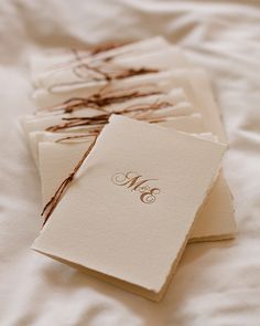 four cards with the initials m and n on them are laid out on a bed