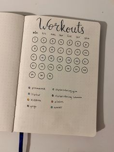 an open notebook with the words workouts written in cursive writing on it