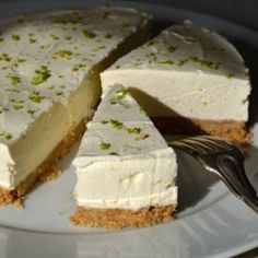 a white plate topped with a cake covered in frosting and green sprinkles