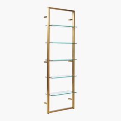 a gold and glass shelf with three shelves on each side, against a white background