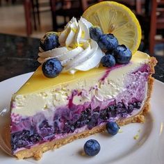 a slice of lemon blueberry cheesecake on a plate