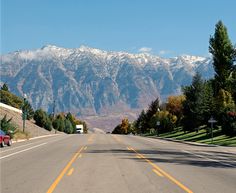 an empty street with mountains in the background