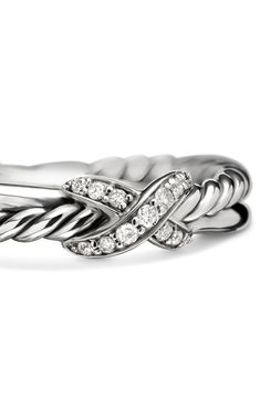 a white gold ring with diamonds in the center and two rows of braiding around it