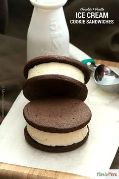 three ice cream sandwiches stacked on top of each other next to a bottle of milk