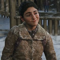 a young boy is standing in the snow