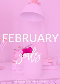 a pink desk with the words, february goals on it and a white coffee mug