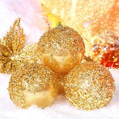 gold glitter christmas ornaments on white fur