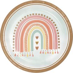 a white plate with a rainbow design on the side and hearts at the bottom in gold trim