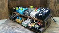 an assortment of pedals and amps are displayed on a table