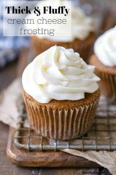 three cupcakes with white frosting on a cooling rack and text overlay that reads, thick & fluffy cream cheese frosting